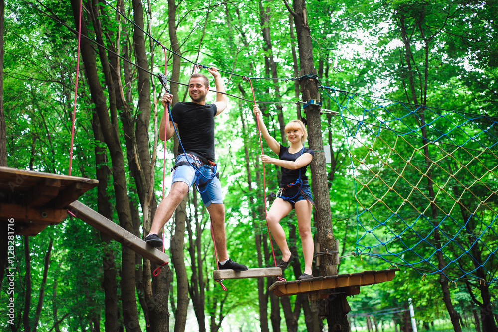 Hiking in the rope park two young people Hiking in the rope park two young people