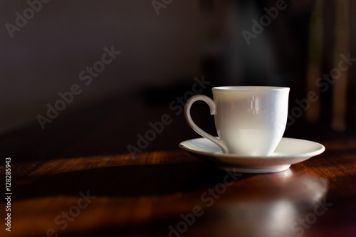 Cup of coffee on table on blured cafe background.