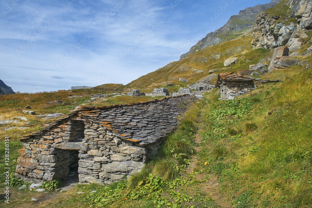 landscape with stone houses in Swiss Alps