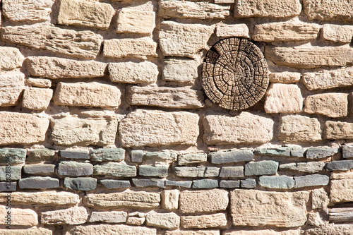 Ancient Pueblo wall with green line and log end at Aztec Ruins National Monument photo