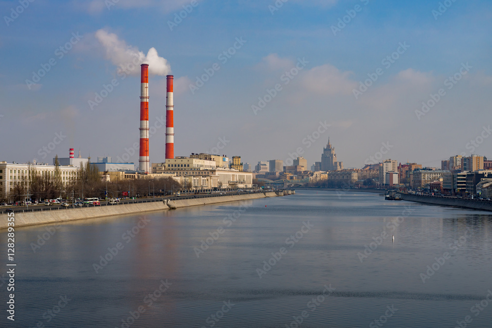 Stalin skyscraper and pipes above Moscow river, Russia