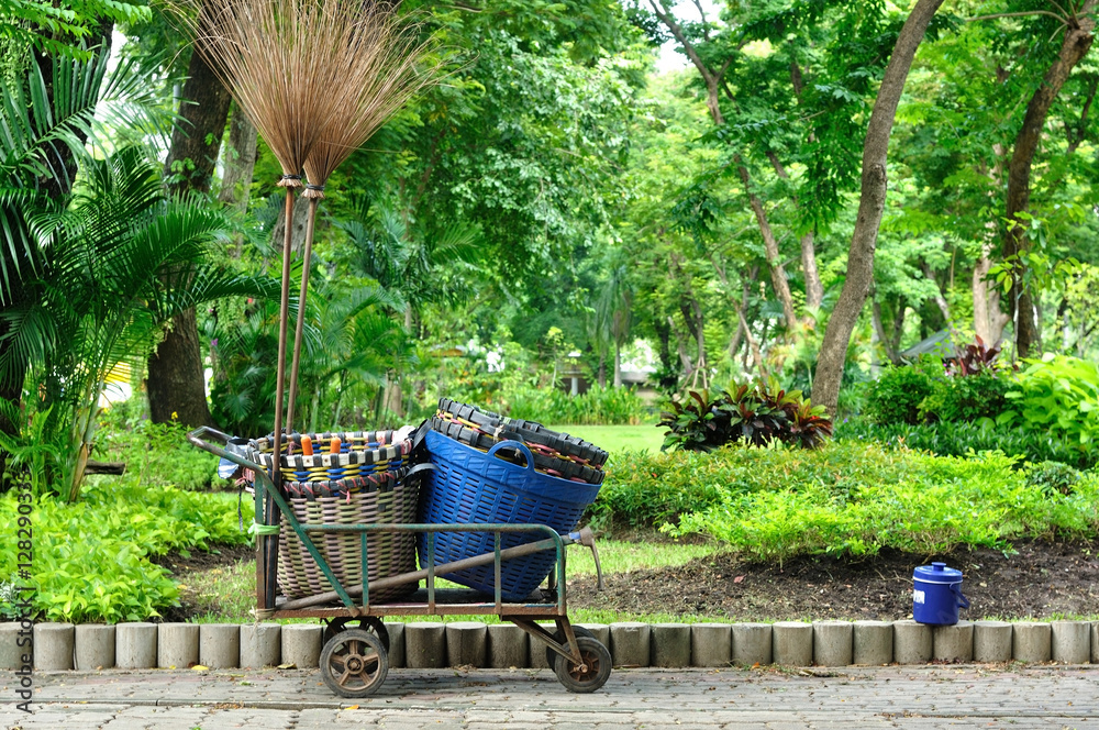 Used trolley contain plastic basket and long broom in gardening