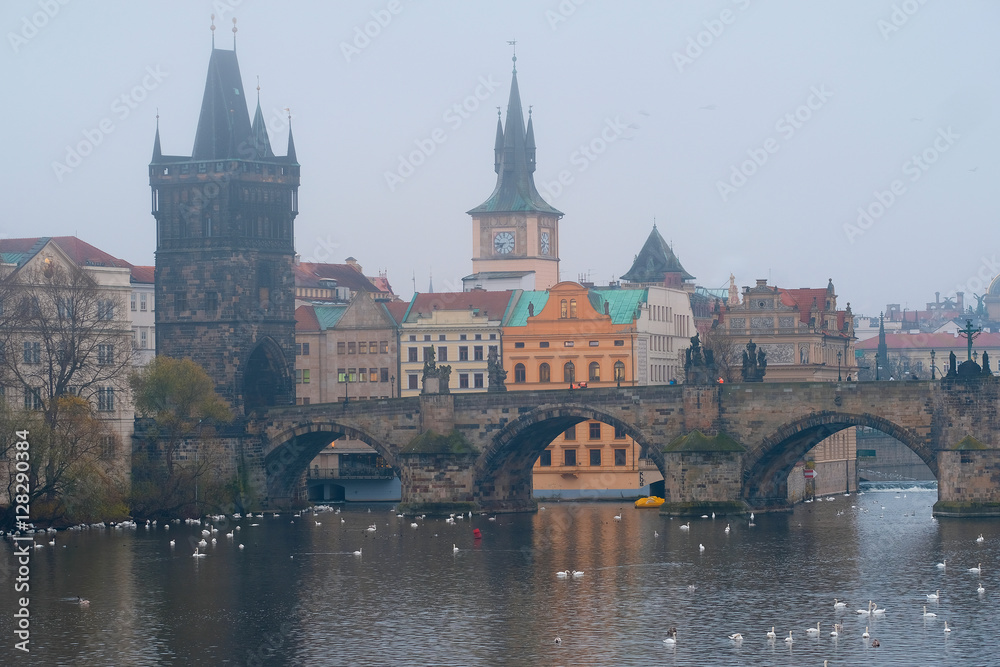 Prague, Czechia - November, 21, 2016: morning fog on Vltava river in Prague, Czechia. There is Charles Bridge in the background. Prague, Czechia - November, 21, 2016: morning fog on Vltava river in Prague, Czechia. There is Charles Bridge in the background.