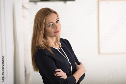 Adult caucasian businesswoman looking confidently at camera in workplace