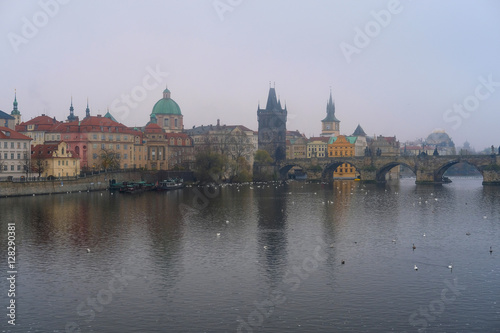 Prague, Czechia - November, 21, 2016: morning fog on Vltava river in Prague, Czechia. There is Charles Bridge in the background.