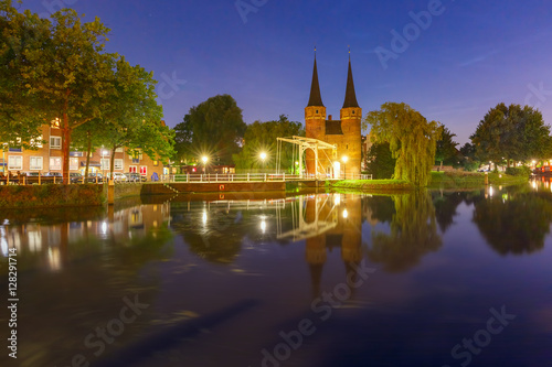 Eastern Gate, Oostpoort, with the white draw bridge, along Delftse Schie canal at night, Delft, Holland, Netherlands
