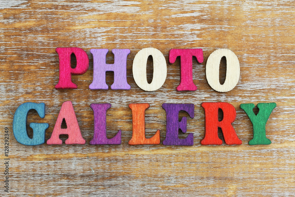 Photo gallery written with colorful letters on rustic wooden surface