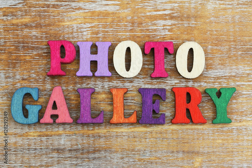 Photo gallery written with colorful letters on rustic wooden surface
