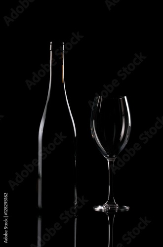 Bottle and vineglass on black background