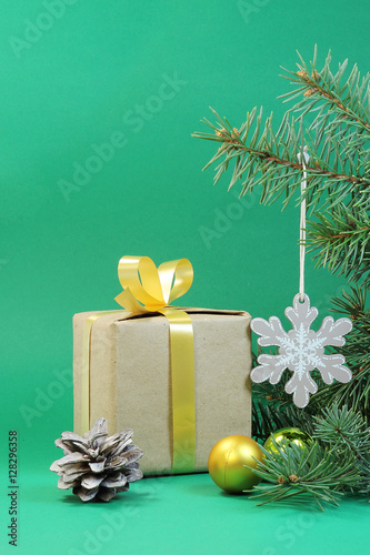 Green background for Christmas card with a gift © helgira