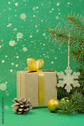 Green background for Christmas card with a gift