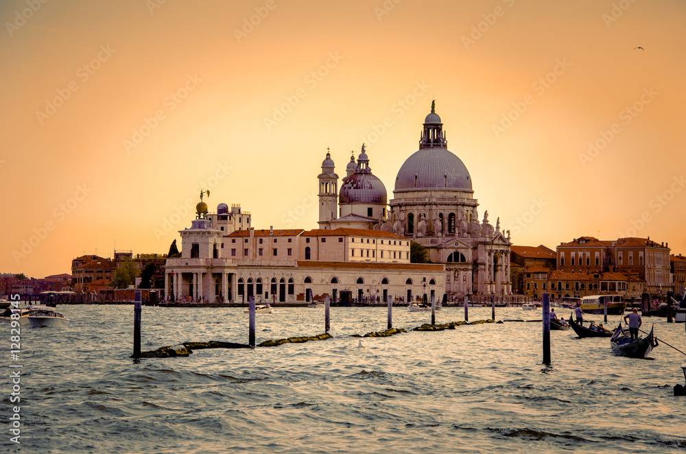 Gondolas on Canal Grande with Basilica di Santa Maria della Salute, Venice, Italy. Sunset colors.