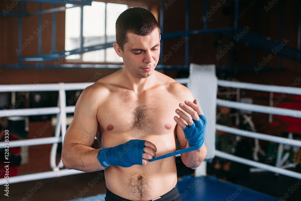 Boxer pulls bandage before the fight or training. Boxer pulls bandage before the fight or training.