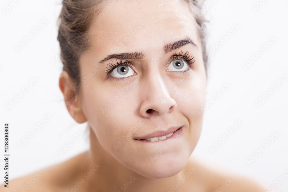 Portrait of young woman who is wondering something, face expression