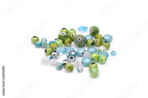 Decorative colorful beads scattered on white background - accessories for handmade and hobby