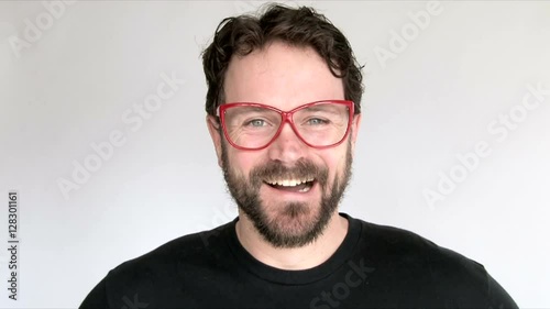 Model released man in studio wearing red nerdy glasses laughing, various clip sequence. photo