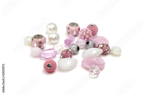 Decorative colorful beads scattered on white background - accessories for handmade and hobby