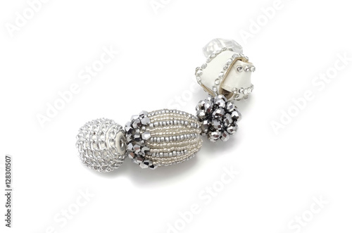 Decorative colorful beads scattered on white background - accessories for handmade and hobby