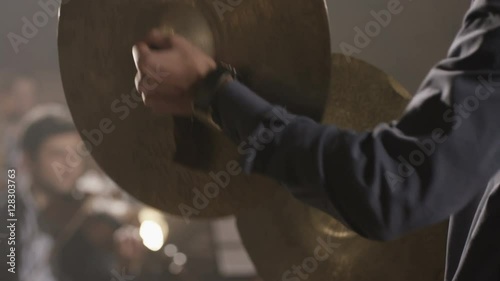 Man playing on ride cymbal on the symphony hall. Shot on RED EPIC Cinema Camera in slow motion.