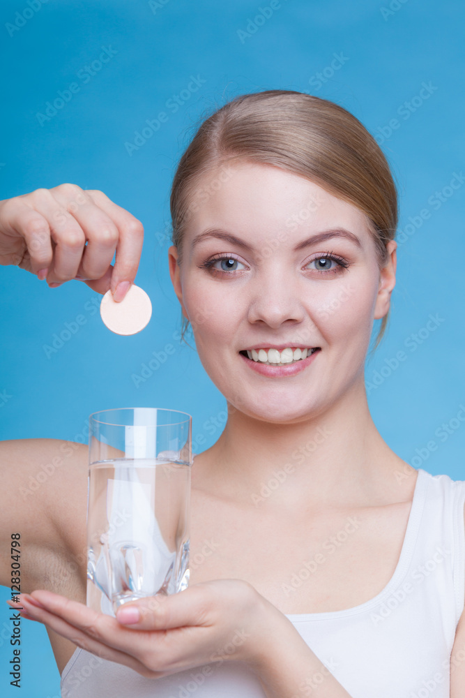 Woman holding glass with water and effervescent tablet Woman holding glass with water and effervescent tablet
