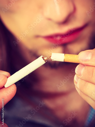 Closeup of man breaking cigarette addiction free