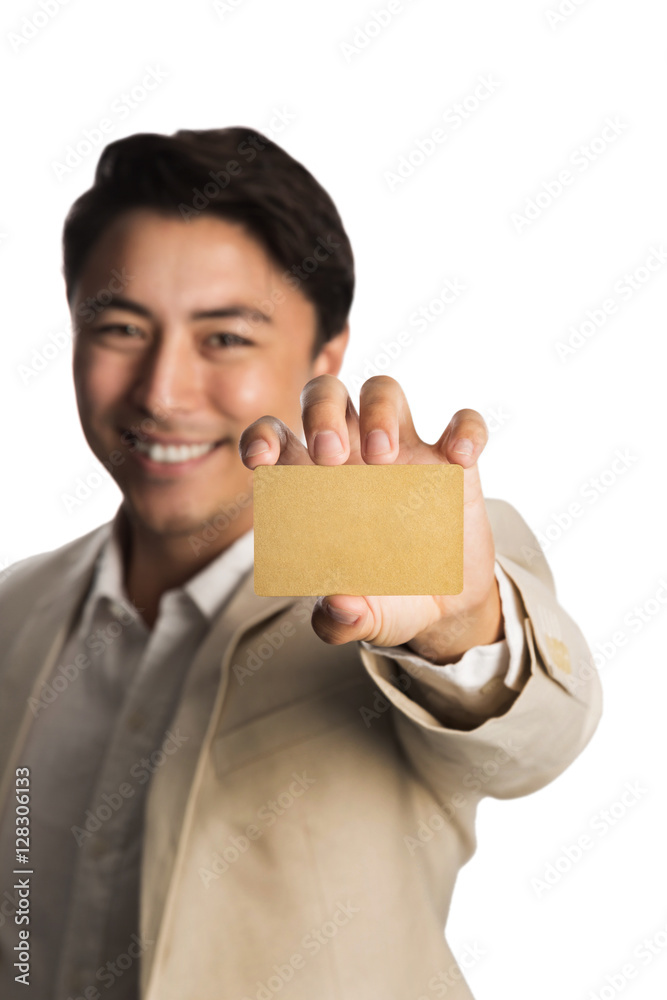 Attractive man in a bright beige suit, holding a golden VIP card smiling towards camera. White background. Attractive man in a bright beige suit, holding a golden VIP card smiling towards camera. White background.