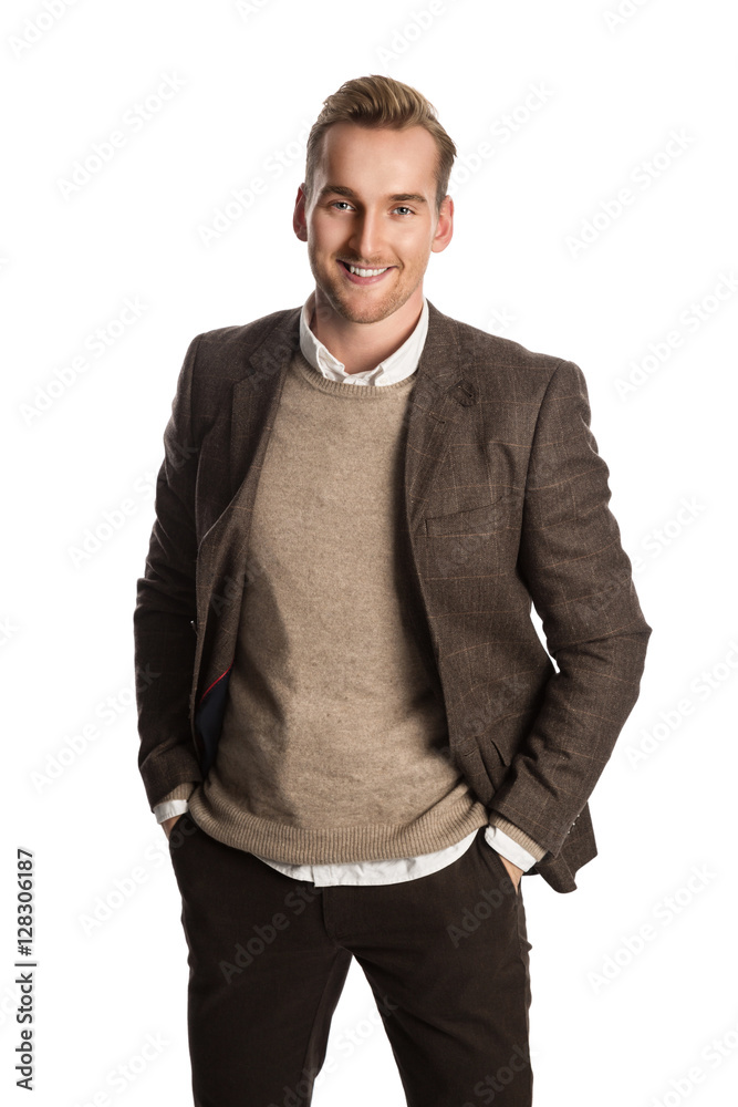 A attractive man in his 20s standing against a white background wearing a brown suit with a sweater and white shirt. A attractive man in his 20s standing against a white background wearing a brown suit with a sweater and white shirt.
