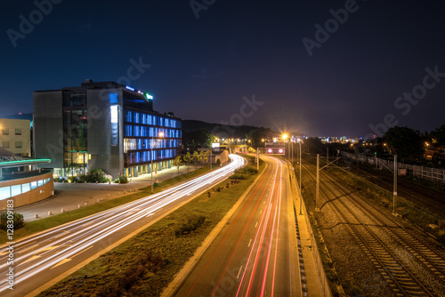 Speed traffic at night in the city of Gdynia. Light trails on the street. Poland.