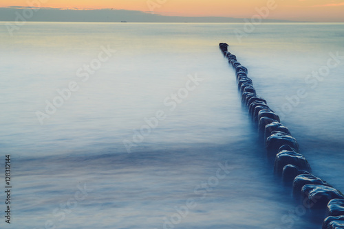 Breakwaters in the Baltic sea over the sunset