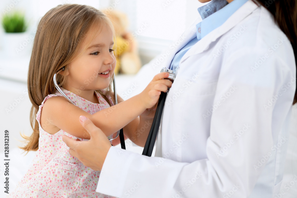 Doctor examining a little girl by stethoscope Doctor examining a little girl by stethoscope