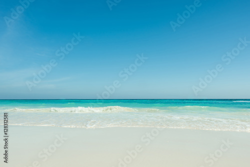 Beautiful gentle wave at the tropical beach with blue sky