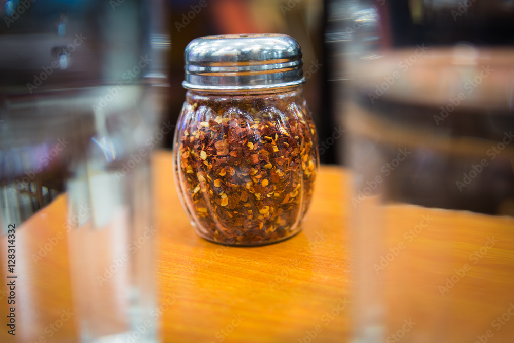 Crushed red pepper flakes in a shaker Crushed red pepper flakes in a shaker