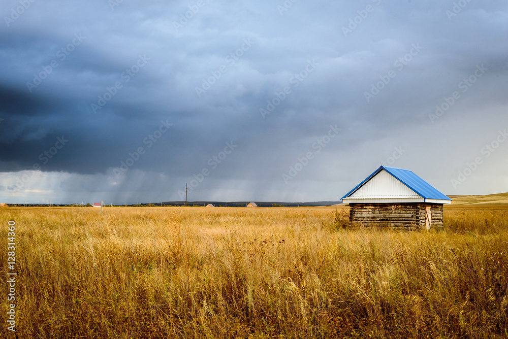 Wooden Hut in a Field With Rain Clouds Wooden Hut in a Field With Rain Clouds