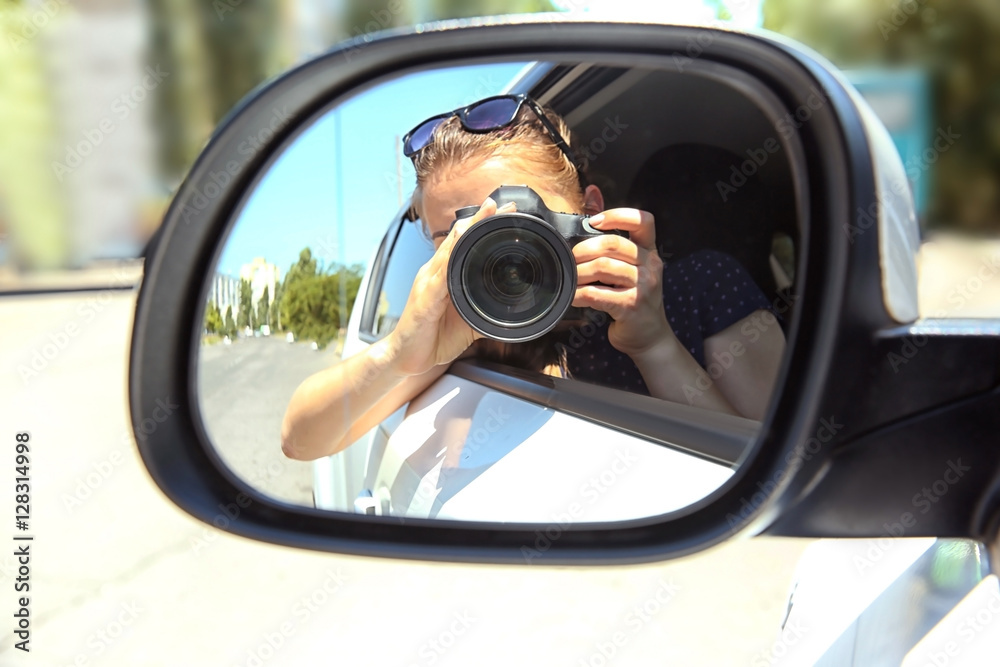 Girl taking photo with camera in moving car Girl taking photo with camera in moving car