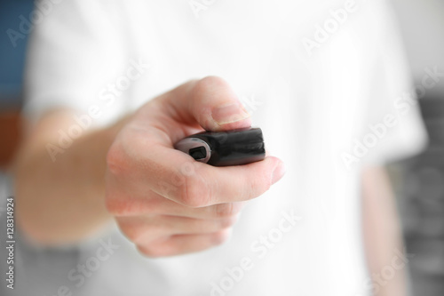 Man hand pressing remote control car alarm
