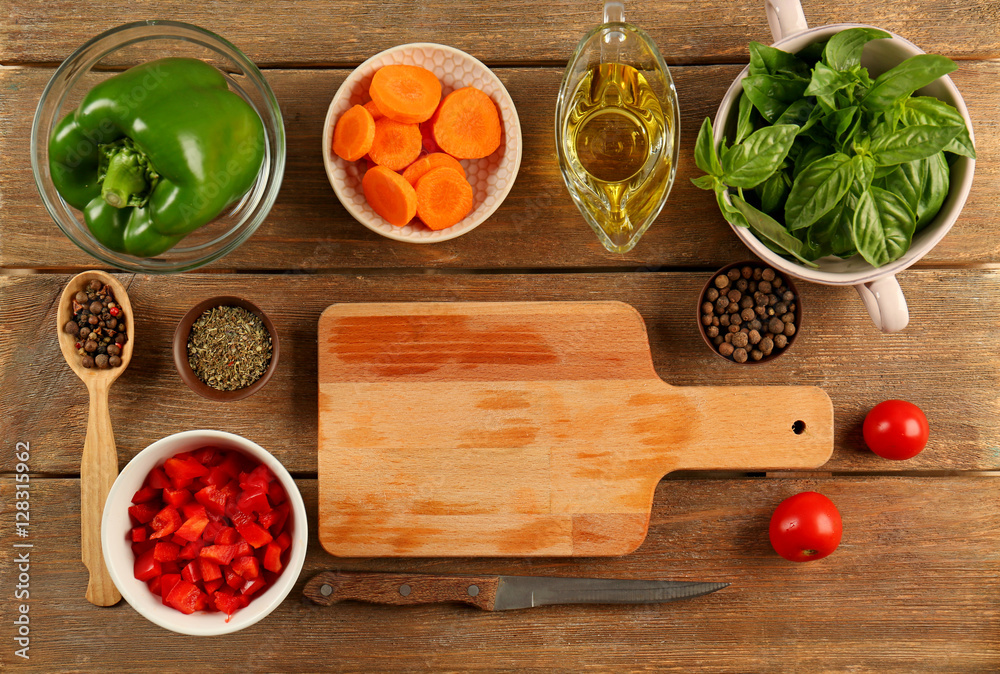 Fresh vegetables for salad with wooden cutting board on table Fresh vegetables for salad with wooden cutting board on table