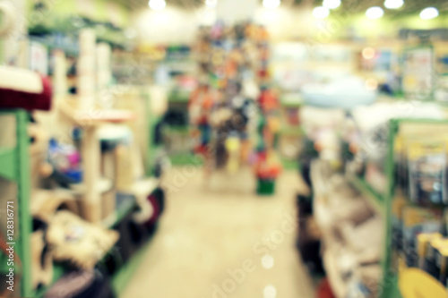 Blurred view of different animal goods on pet shop shelves