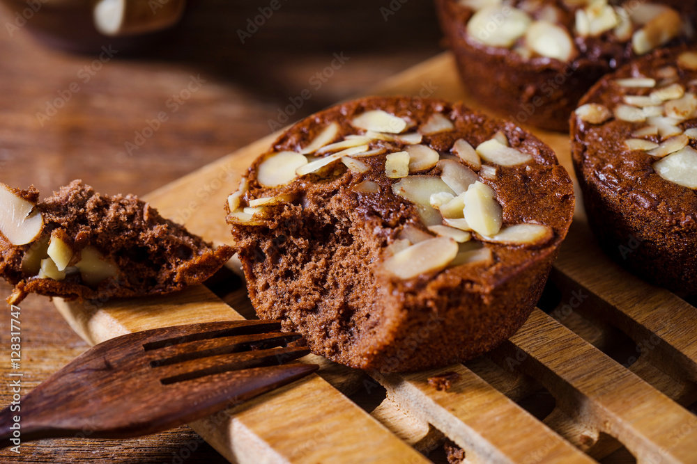 Homemade delicious fresh chocolate and almonds cake on wooden ta