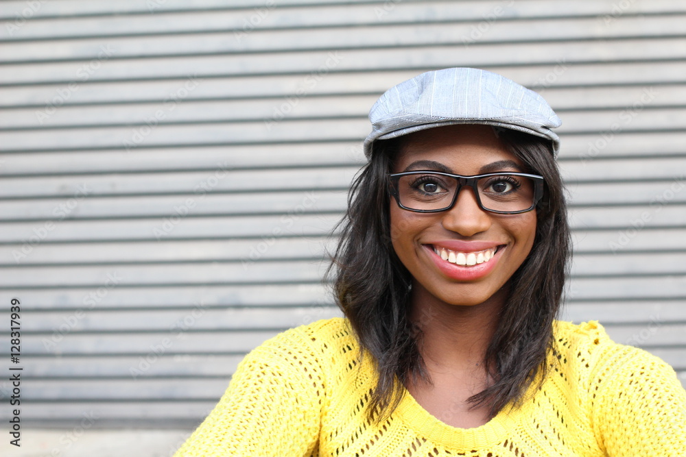 Healthy hip African woman with glasses and fancy hat showing happiness with space for copy Healthy hip African woman with glasses and fancy hat showing happiness with space for copy