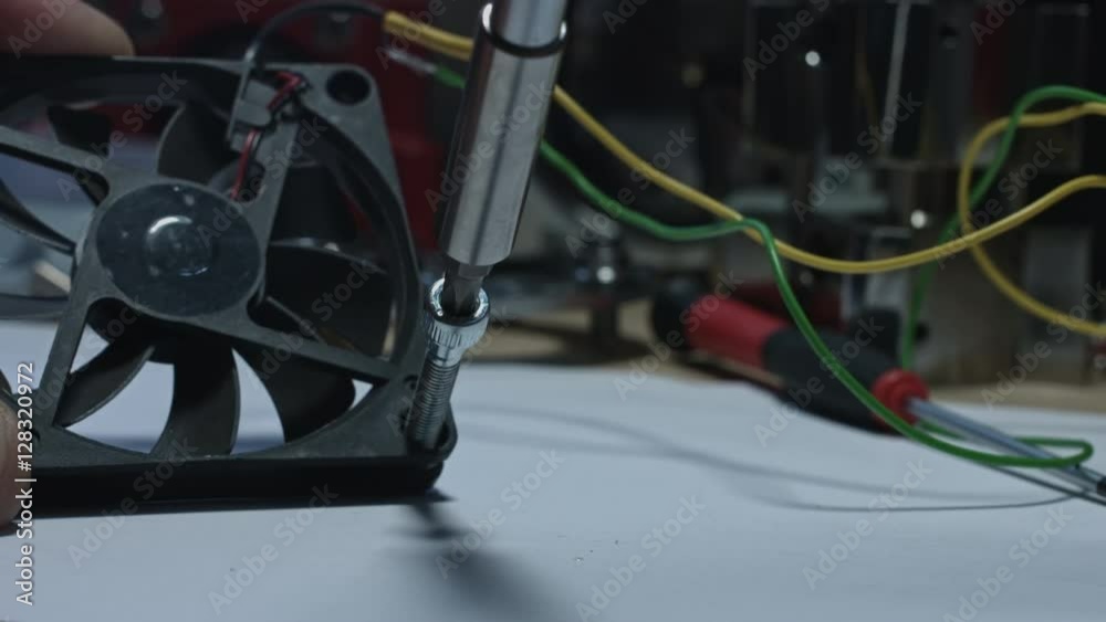 4k technical composition of a screwdriver putting bolts into a fan 4k technical composition of a screwdriver putting bolts into a fan