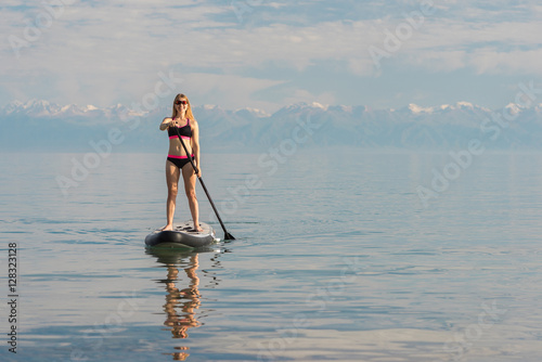 Happy woman on paddle board  photo