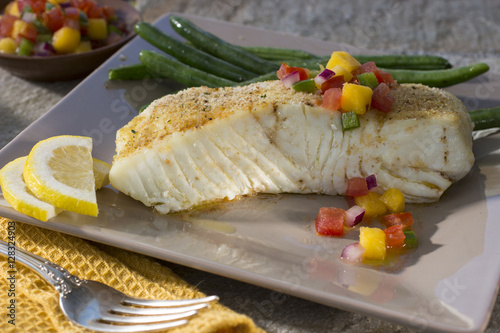 Fotografia Alaskan Halibut Served on Dinner Plate with Tropical Mango Salsa and Green Beans