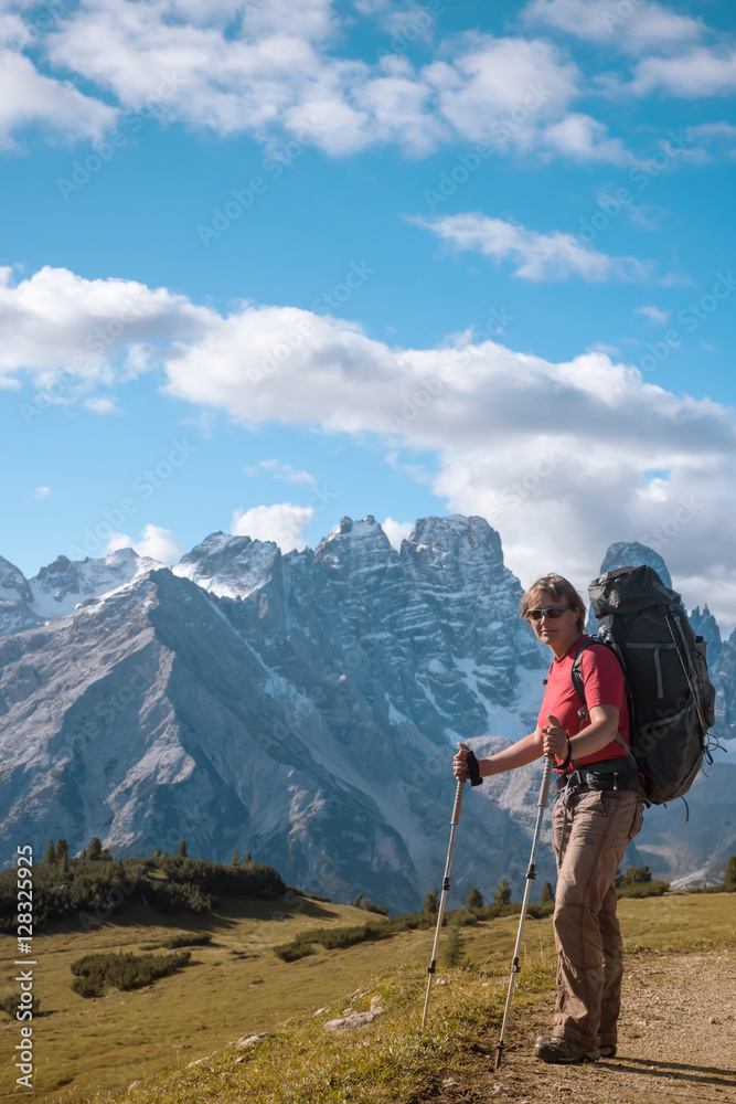 hiker in front of Alps mountains