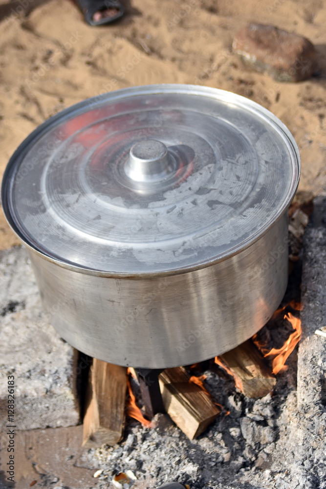 COOKING RICE AND MEAT OVER THE CHARCOAL AND WOOD IN THE PARK, DUBAI,UAE COOKING RICE AND MEAT OVER THE CHARCOAL AND WOOD IN THE PARK, DUBAI,UAE