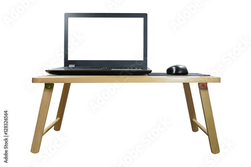 Closeup front view of the laptop and wireless mouse on the wood table isolated on white background.