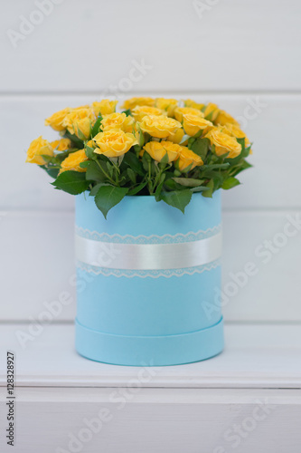 Round blue gift box with yellow roses