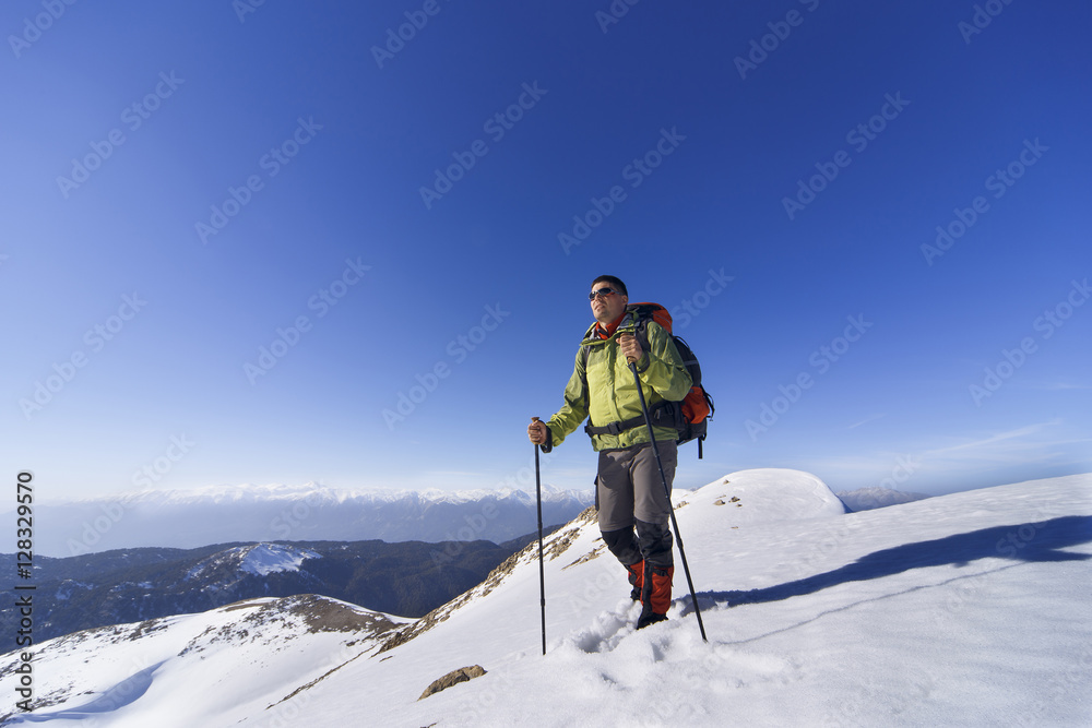 Winter hiking in the mountains with a backpack.