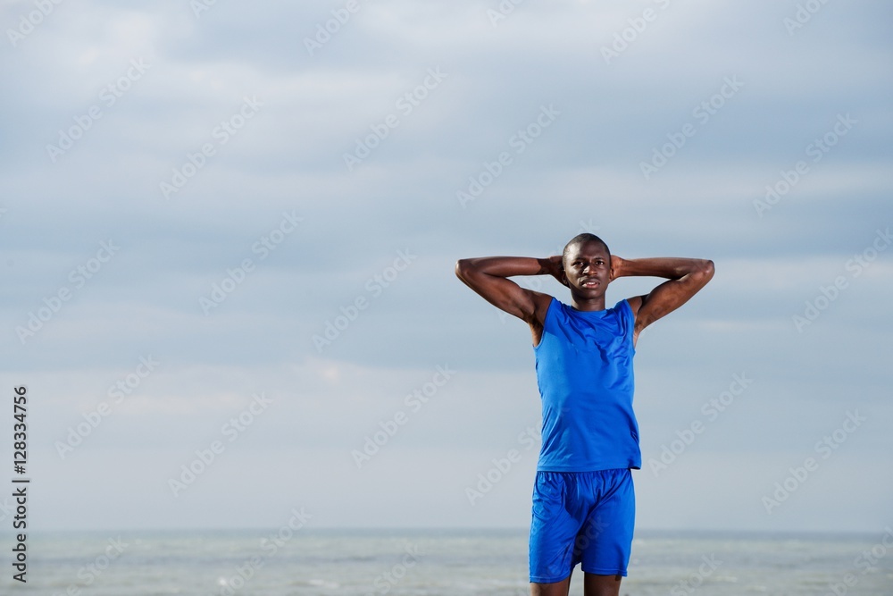 Fit young african man working out on the beach Fit young african man working out on the beach