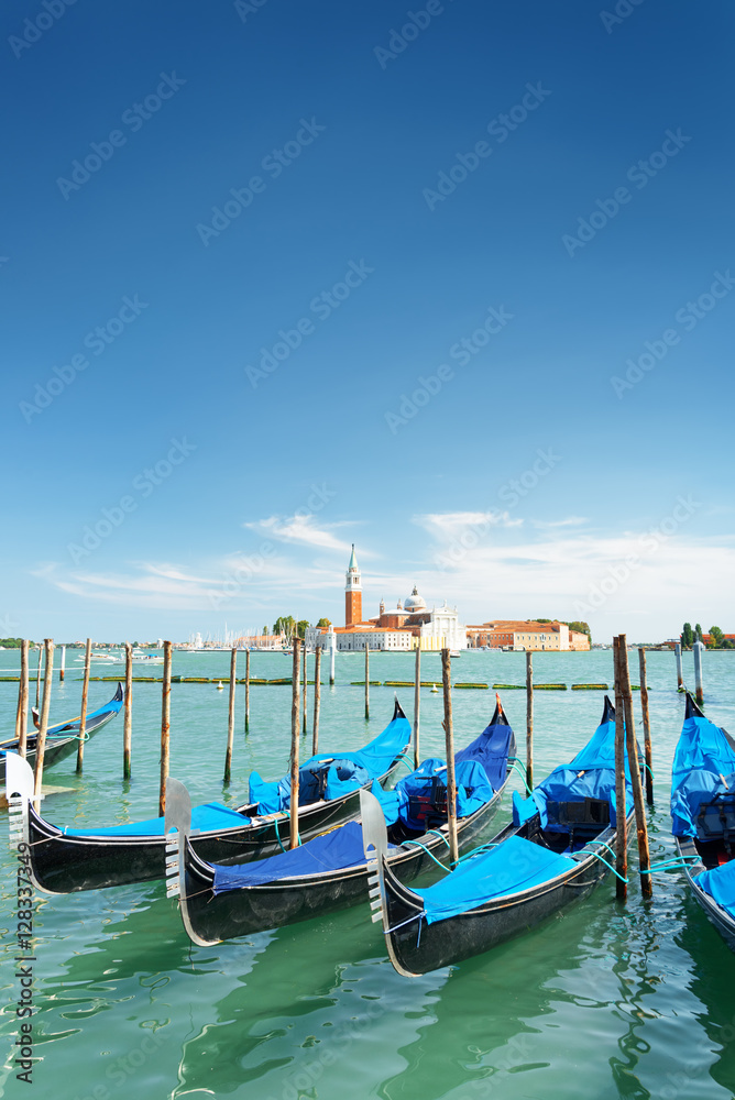 Several gondolas parked beside the Riva degli Schiavoni, Venice