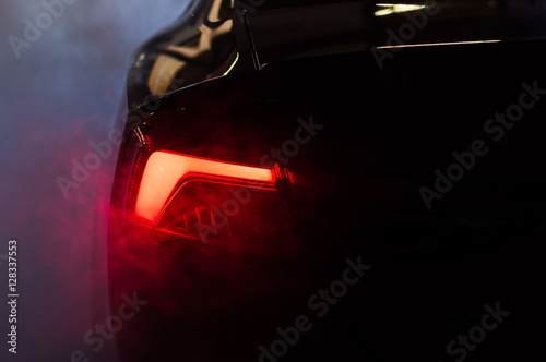 Car red taillights with smoke fog around it